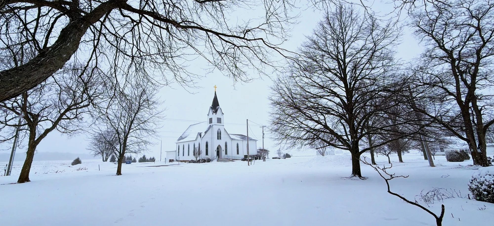 Immanuel Lutheran Church in winter, bare trees framing the building
