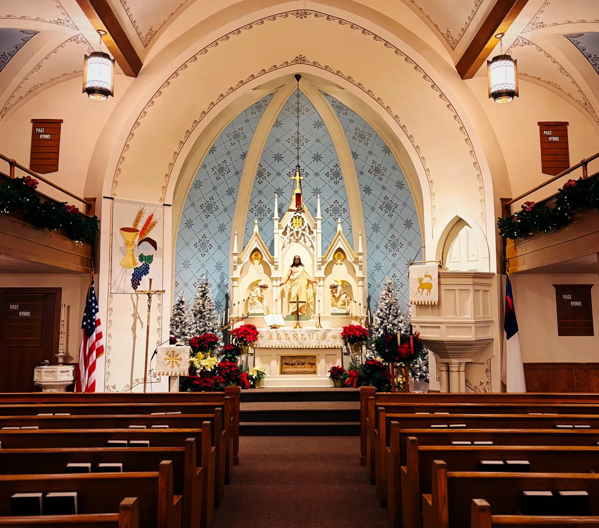 The nave of Immanuel Lutheran Church during the Christmas season, poinsettias banked around the altar